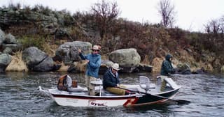 Anglers fly fishing from a drift boat